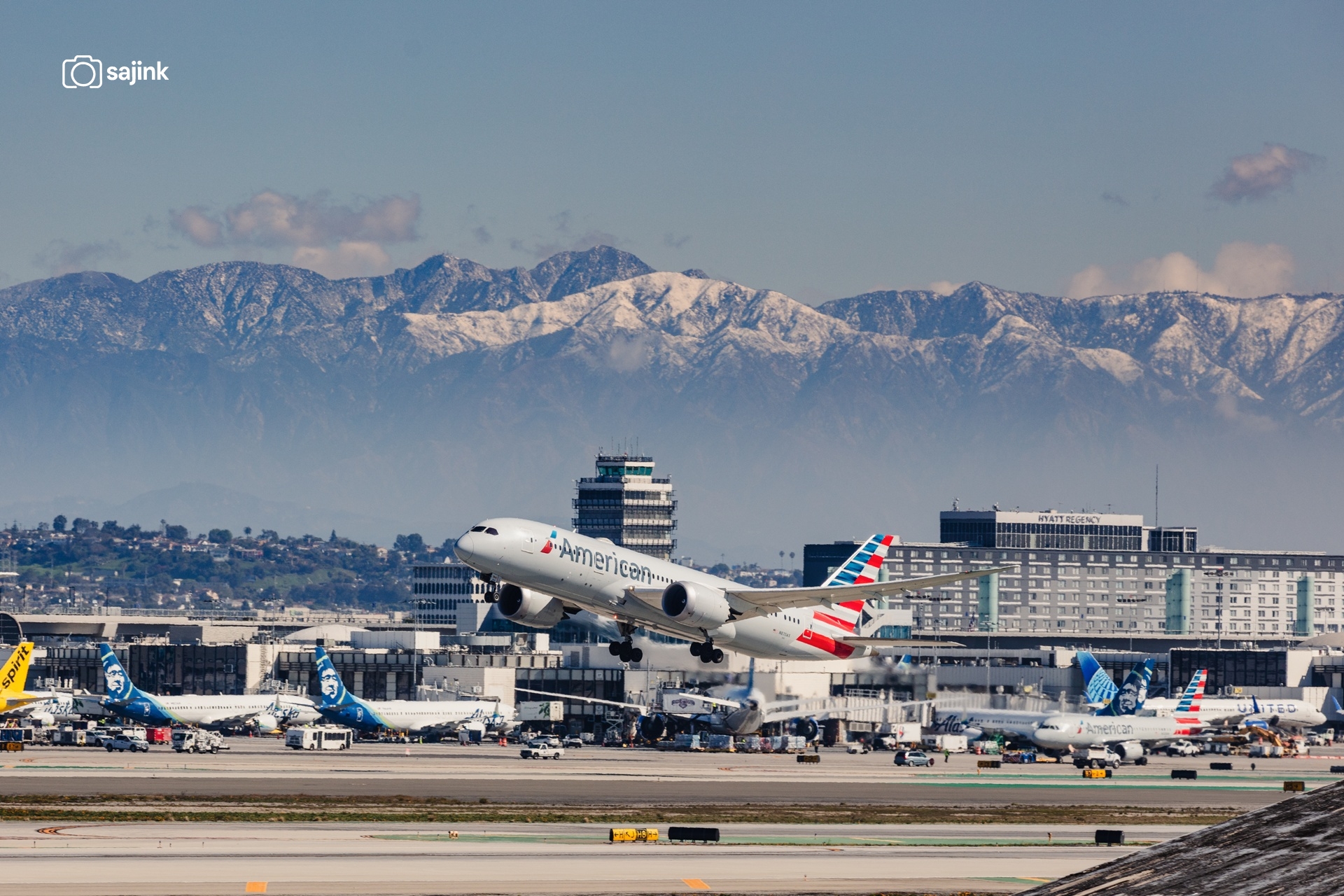 American Airlines Airbus Departure at LAX Framed by Snowy Peaks